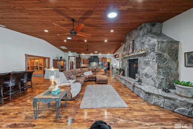 951 Riverview Dr, Gardnerville, NV 89460 - living room featuring wooden ceiling, ceiling fan, wood finished floors, a stone fireplace, and vaulted ceiling