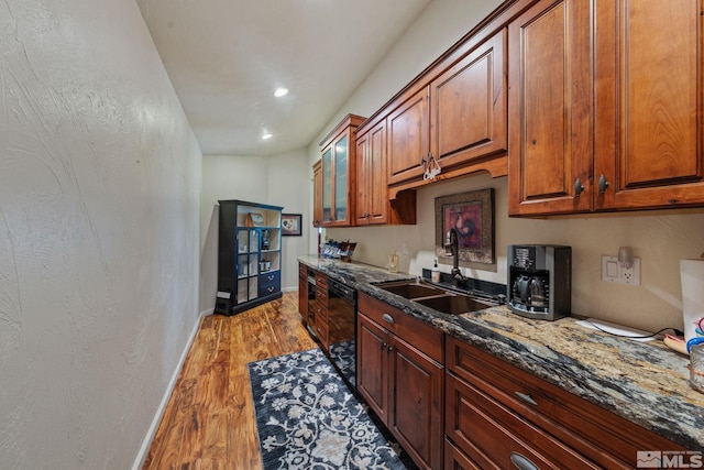 951 Riverview Dr, Gardnerville, NV 89460 - kitchen with a sink, light wood-type flooring, dishwasher, dark stone countertops, and baseboards
