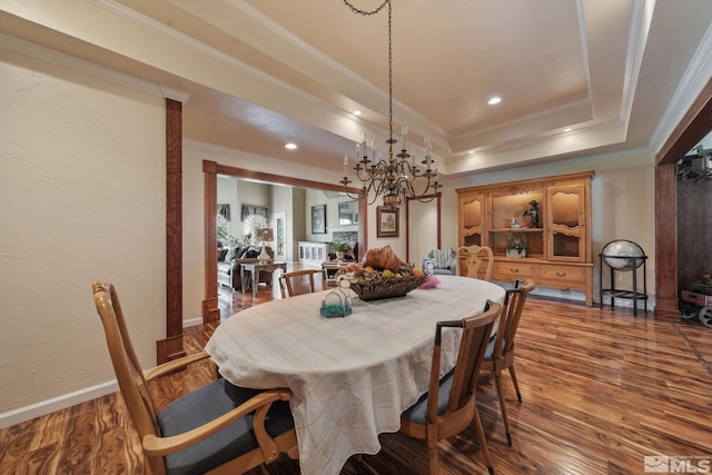 951 Riverview Dr, Gardnerville, NV 89460 - dining room with a chandelier, crown molding, wood finished floors, a tray ceiling, and baseboards
