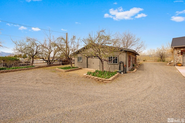 951 Riverview Dr, Gardnerville, NV 89460 - view of front of home featuring an outdoor structure, driveway, and an attached garage