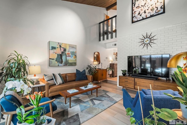 living room featuring a high ceiling and wood finished floors