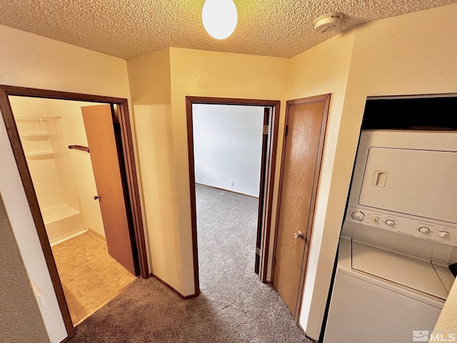 4985 W 7th St Unit 11, Reno, NV 89503 - hall featuring estacked washer and dryer, carpet, and a textured ceiling
