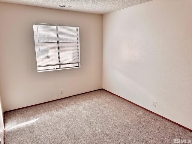 4985 W 7th St Unit 11, Reno, NV 89503 - spare room featuring carpet, a textured ceiling, and baseboards
