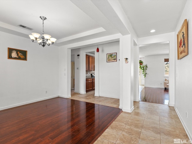 7730 Opal Blf, Reno, NV 89506 - unfurnished room featuring a chandelier, baseboards, light wood finished floors, a raised ceiling, and recessed lighting