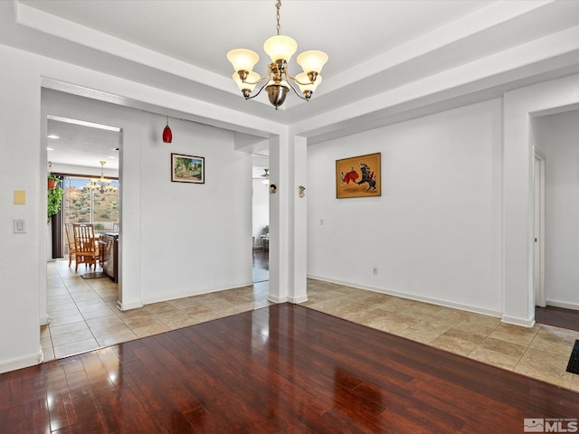 7730 Opal Blf, Reno, NV 89506 - unfurnished dining area featuring a chandelier, hardwood / wood-style flooring, and baseboards