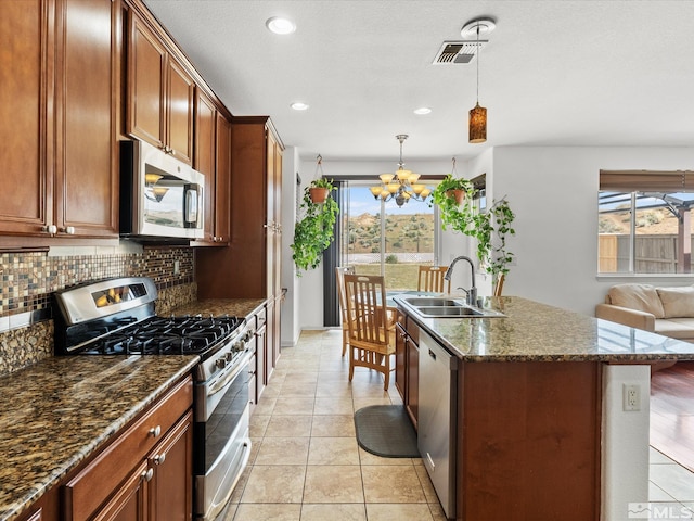 7730 Opal Blf, Reno, NV 89506 - kitchen with appliances with stainless steel finishes, a sink, a chandelier, decorative backsplash, and recessed lighting