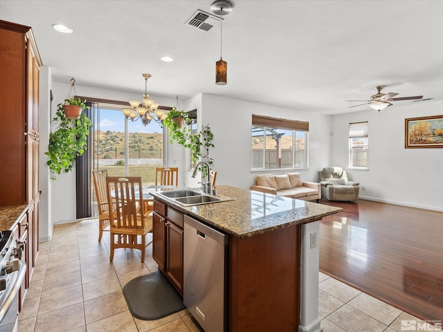 7730 Opal Blf, Reno, NV 89506 - kitchen featuring appliances with stainless steel finishes, a sink, a chandelier, a kitchen island with sink, and light tile patterned floors