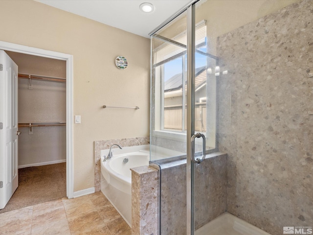 7730 Opal Blf, Reno, NV 89506 - bathroom featuring plenty of natural light, a shower stall, a walk in closet, and a garden tub