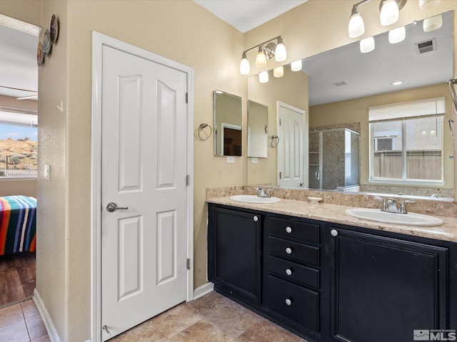 7730 Opal Blf, Reno, NV 89506 - bathroom with ensuite bath, a shower stall, double vanity, tile patterned floors, and baseboards