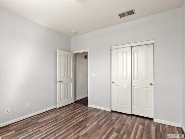 7730 Opal Blf, Reno, NV 89506 - unfurnished bedroom with dark wood finished floors, baseboards, and a closet