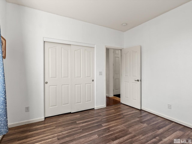 7730 Opal Blf, Reno, NV 89506 - unfurnished bedroom with dark wood-type flooring, baseboards, and a closet