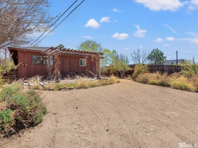 view of yard featuring a pergola and fence
