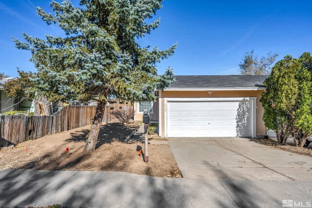 6735 Peppermint Dr, Reno, NV 89506 - view of front facade with driveway, stucco siding, fence, and a garage