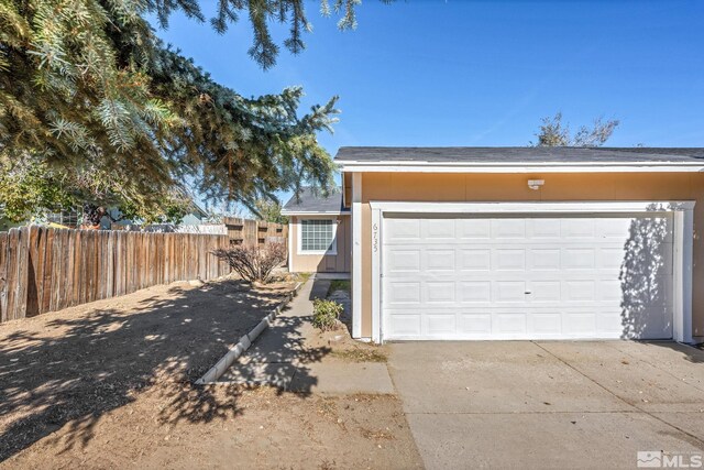 6735 Peppermint Dr, Reno, NV 89506 - view of property exterior with fence, driveway, and a garage
