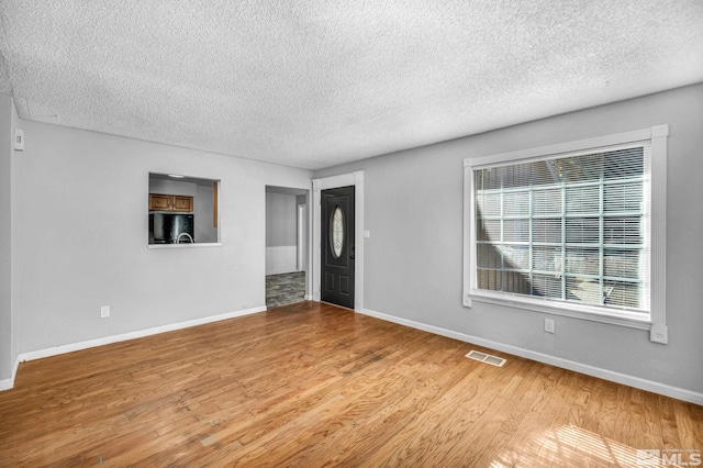 6735 Peppermint Dr, Reno, NV 89506 - empty room with a textured ceiling, baseboards, and wood finished floors