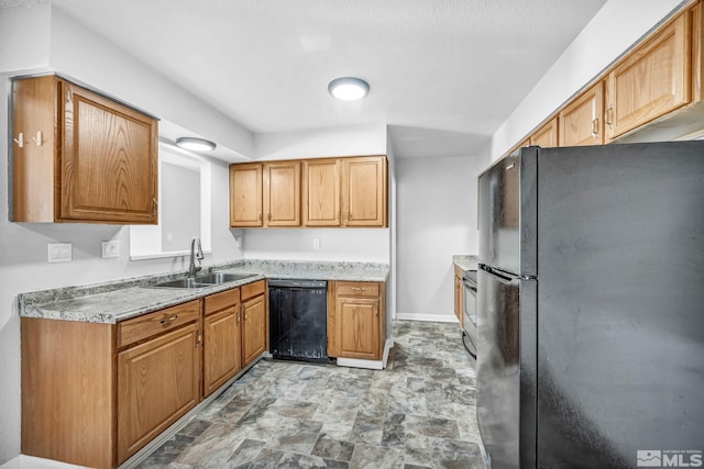 6735 Peppermint Dr, Reno, NV 89506 - kitchen with black appliances, a sink, stone finish floors, light countertops, and baseboards
