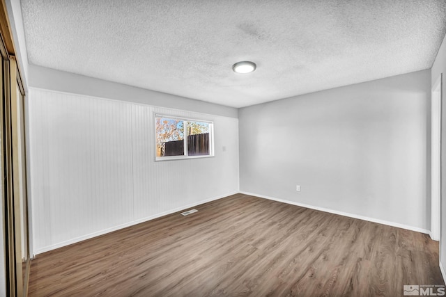 6735 Peppermint Dr, Reno, NV 89506 - spare room featuring wood finished floors, baseboards, and a textured ceiling