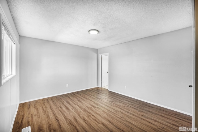 6735 Peppermint Dr, Reno, NV 89506 - unfurnished room featuring wood finished floors, a textured ceiling, and baseboards