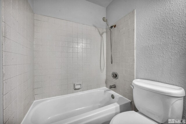 6735 Peppermint Dr, Reno, NV 89506 - bathroom featuring toilet, tub / shower combination, and a textured wall