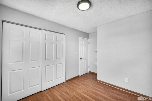 6735 Peppermint Dr, Reno, NV 89506 - unfurnished bedroom with a textured ceiling, light wood-type flooring, a closet, and baseboards