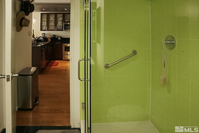 255 N Sierra St Unit 708, Reno, NV 89501 - bathroom with wood finished floors, a shower stall, and a sink