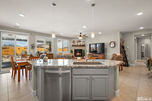 1180 Ferretto Pkwy, Dayton, NV 89403 - kitchen with dishwasher, a sink, gray cabinetry, a tiled fireplace, and open floor plan