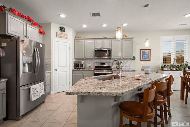 1180 Ferretto Pkwy, Dayton, NV 89403 - kitchen featuring appliances with stainless steel finishes, gray cabinets, light tile patterned floors, a sink, and recessed lighting