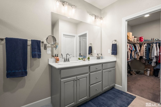 1180 Ferretto Pkwy, Dayton, NV 89403 - full bath featuring double vanity, a walk in closet, and baseboards