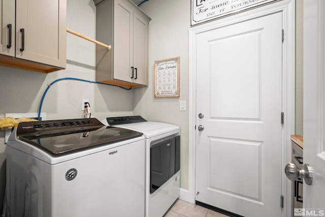 1180 Ferretto Pkwy, Dayton, NV 89403 - laundry room with cabinet space, washer and clothes dryer, and light tile patterned flooring