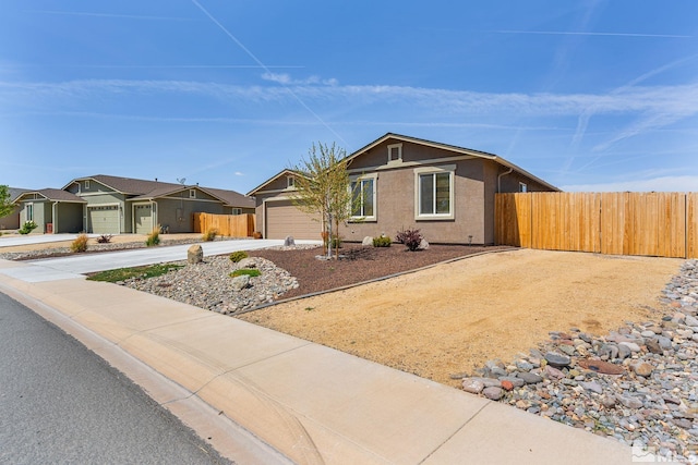 1180 Ferretto Pkwy, Dayton, NV 89403 - ranch-style home featuring fence, a garage, concrete driveway, and stucco siding