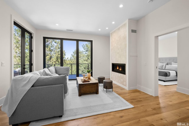 2531 Edgerock Rd, Reno, NV 89519 - living area with plenty of natural light, light wood-style floors, recessed lighting, a tiled fireplace, and baseboards