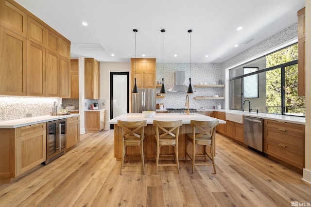 2531 Edgerock Rd, Reno, NV 89519 - kitchen with stainless steel appliances, beverage cooler, wall chimney exhaust hood, a sink, and backsplash