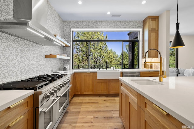 2531 Edgerock Rd, Reno, NV 89519 - kitchen with wall chimney exhaust hood, appliances with stainless steel finishes, a sink, light wood-type flooring, and recessed lighting