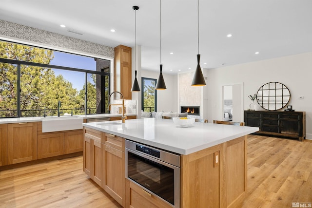 2531 Edgerock Rd, Reno, NV 89519 - kitchen featuring a sink, light wood-type flooring, a large fireplace, recessed lighting, and light countertops