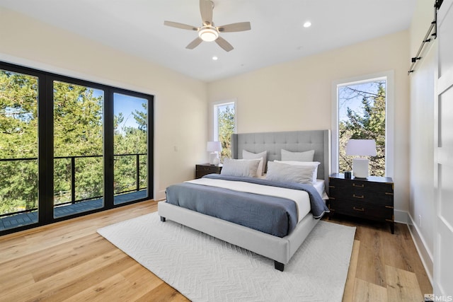 2531 Edgerock Rd, Reno, NV 89519 - bedroom with a barn door, light wood finished floors, recessed lighting, and ceiling fan