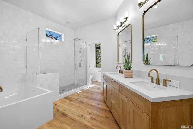 2531 Edgerock Rd, Reno, NV 89519 - bathroom with wood finished floors, a shower stall, a freestanding bath, double vanity, and toilet