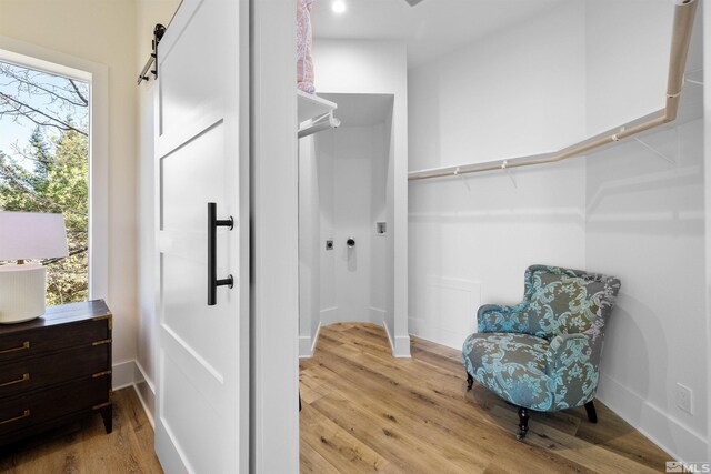 2531 Edgerock Rd, Reno, NV 89519 - walk in closet with a barn door and light wood-type flooring