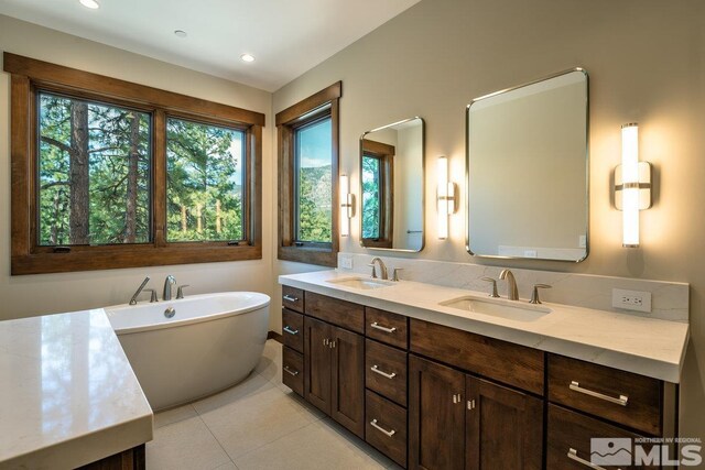 534 Headwaters Way, Carson City, NV 89705 - bathroom featuring a freestanding bath, double vanity, tile patterned flooring, and recessed lighting