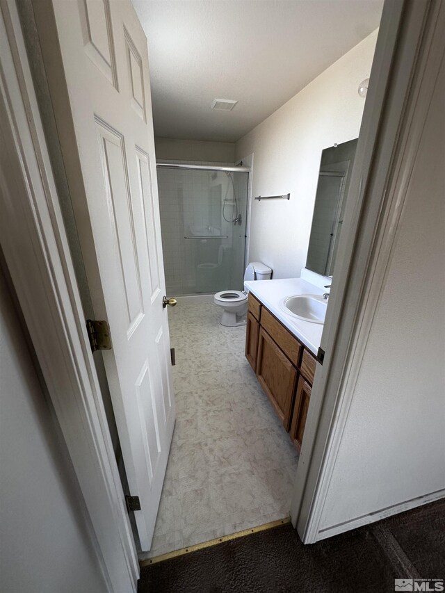 2037 Lonnie Ln, Dayton, NV 89403 - bathroom featuring a shower with door, toilet, and vanity
