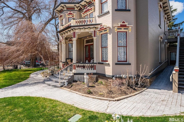102 N Curry St, Carson City, NV 89703 - view of front of home featuring a balcony and brick siding