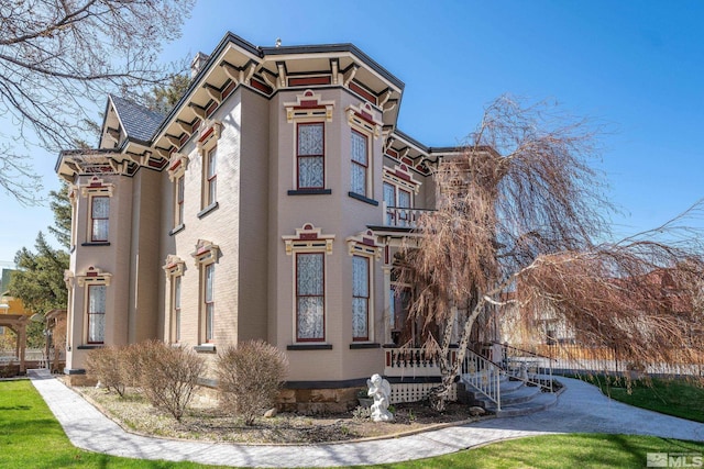 102 N Curry St, Carson City, NV 89703 - view of side of home with a yard and brick siding