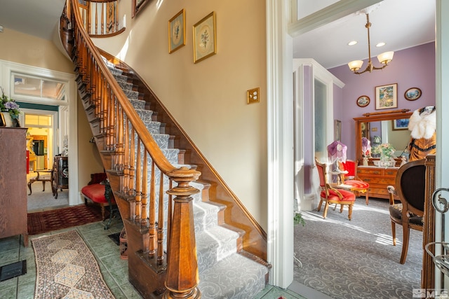 102 N Curry St, Carson City, NV 89703 - stairway featuring carpet flooring, a chandelier, recessed lighting, and a towering ceiling