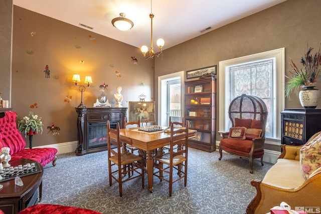 102 N Curry St, Carson City, NV 89703 - dining room featuring a glass covered fireplace, baseboards, and a chandelier