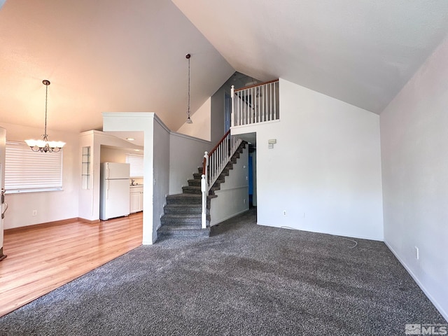 2621 Fanto Ct, Sparks, NV 89431 - unfurnished living room with carpet, a chandelier, stairs, baseboards, and high vaulted ceiling