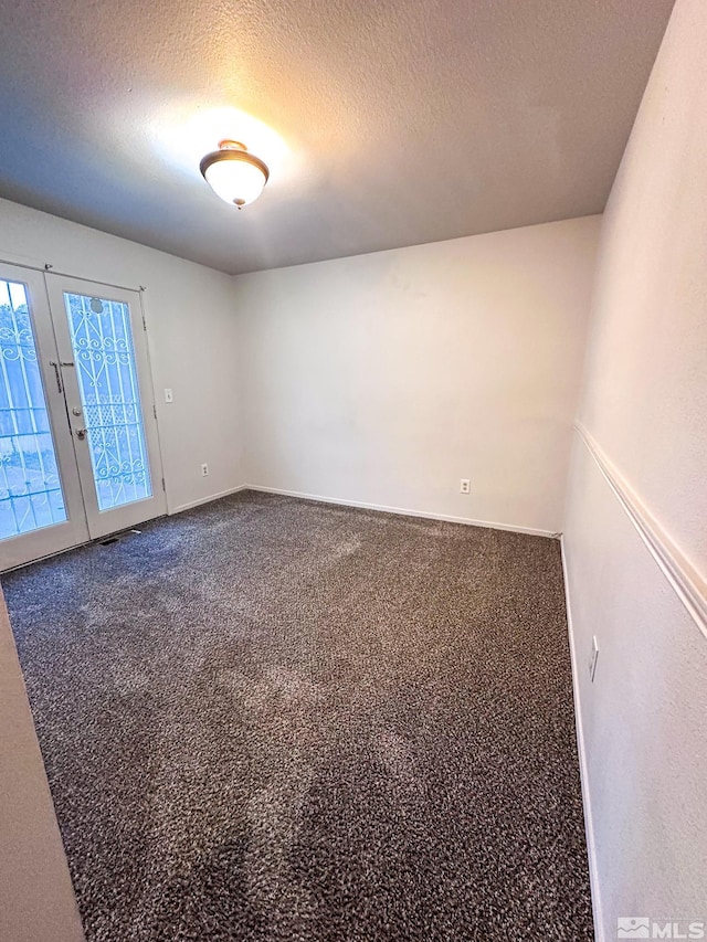 2621 Fanto Ct, Sparks, NV 89431 - unfurnished room featuring french doors, a textured ceiling, dark carpet, and baseboards