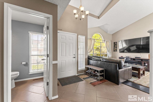 4776 Scenic Hill Cir, Reno, NV 89523 - entryway featuring a chandelier, vaulted ceiling, a textured ceiling, and baseboards