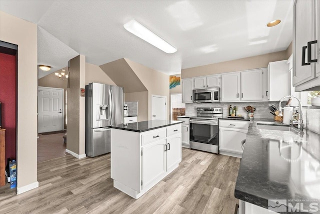 4776 Scenic Hill Cir, Reno, NV 89523 - kitchen featuring appliances with stainless steel finishes, a center island, a sink, and light wood finished floors