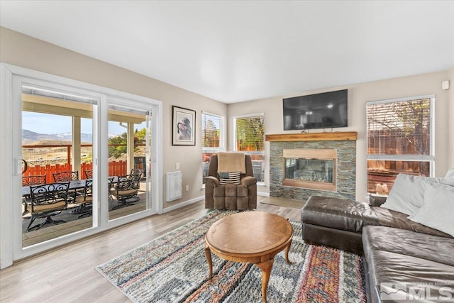 4776 Scenic Hill Cir, Reno, NV 89523 - living room featuring wood finished floors, plenty of natural light, a fireplace, and baseboards