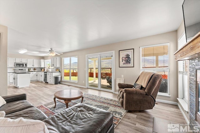 4776 Scenic Hill Cir, Reno, NV 89523 - living room with light wood-type flooring, healthy amount of natural light, and baseboards