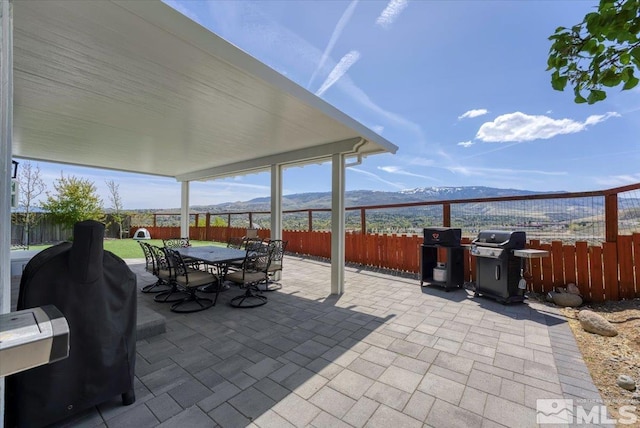 4776 Scenic Hill Cir, Reno, NV 89523 - view of patio featuring a mountain view, grilling area, and a fenced backyard